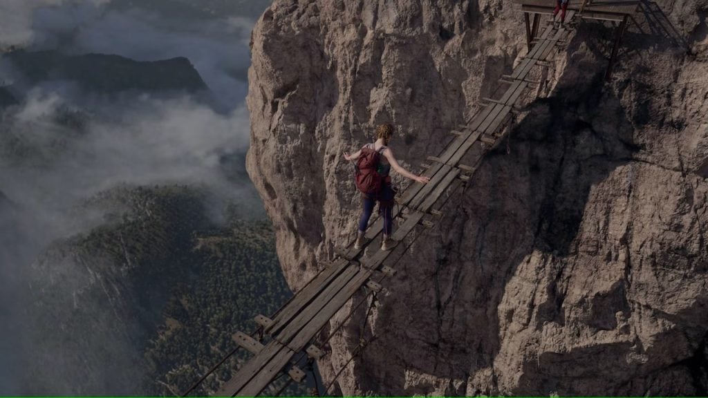 Fall 2 movie still showing actors struggling on the edge of a high cliff